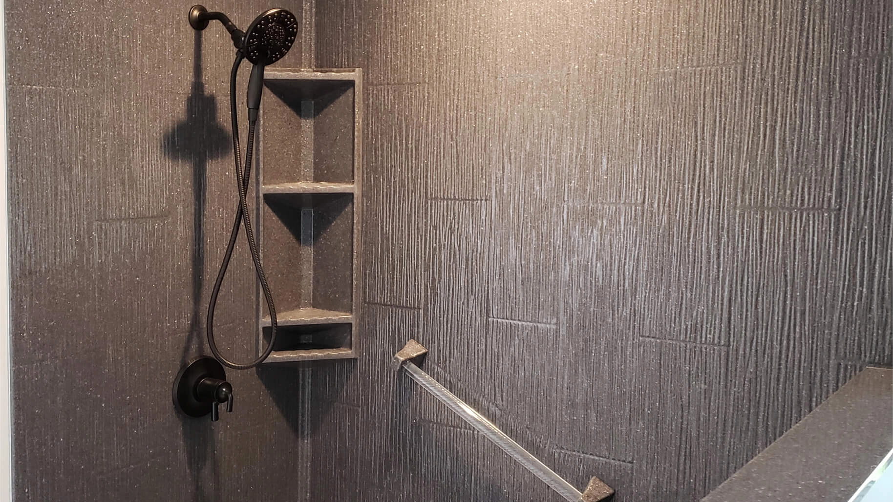 An elegant shower corner showcasing Shiplap style Onyx wall panels in a dark hue with a linear texture